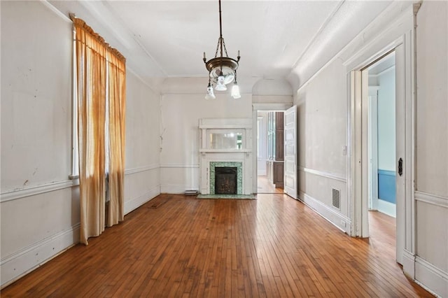 unfurnished living room featuring wood-type flooring and a fireplace