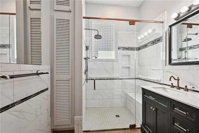 bathroom with vanity and a shower with door