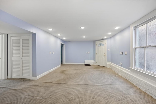 carpeted spare room featuring plenty of natural light