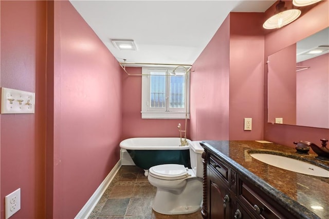 bathroom with vanity, toilet, and a tub to relax in