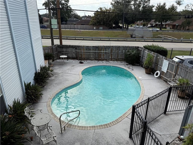 view of swimming pool featuring a patio area