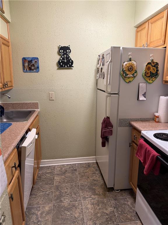 kitchen featuring sink and white appliances