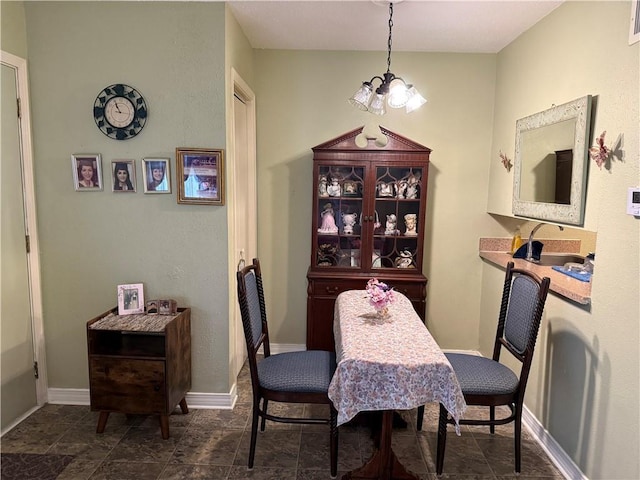 dining room with a notable chandelier and sink