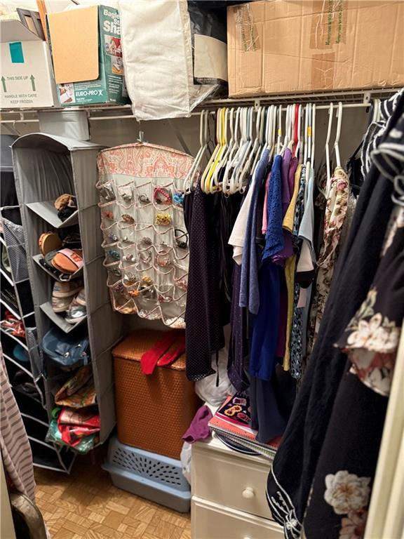 spacious closet featuring parquet flooring