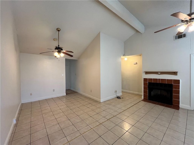 unfurnished living room featuring light tile patterned floors, lofted ceiling with beams, ceiling fan, and a tiled fireplace