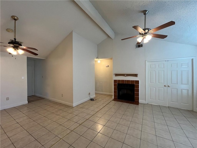 unfurnished living room with ceiling fan, light tile patterned flooring, and a fireplace