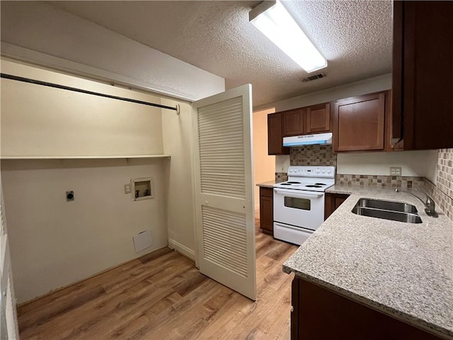 kitchen with decorative backsplash, a textured ceiling, sink, light hardwood / wood-style flooring, and white range with electric cooktop