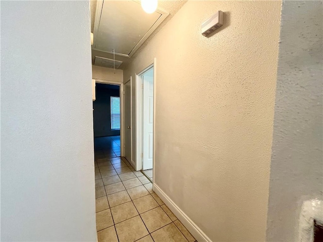 hall featuring light tile patterned floors