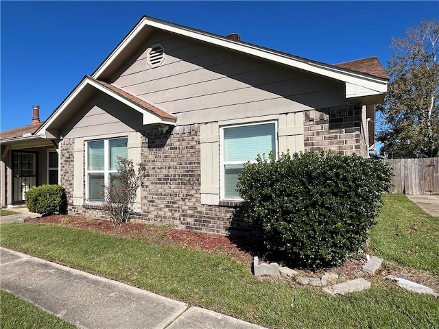 view of property exterior with a lawn