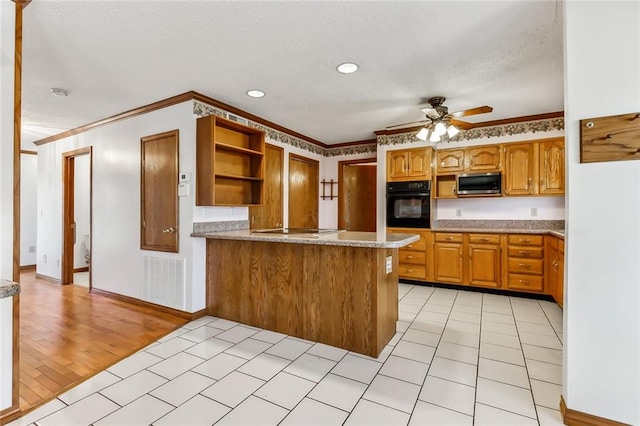 kitchen featuring ceiling fan, light hardwood / wood-style flooring, kitchen peninsula, black oven, and ornamental molding