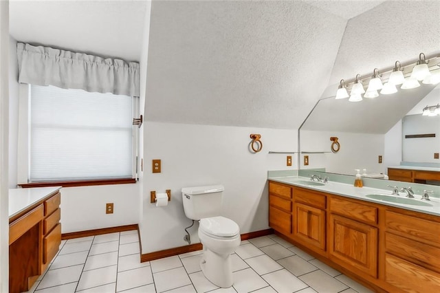 bathroom with vanity, a textured ceiling, vaulted ceiling, and toilet