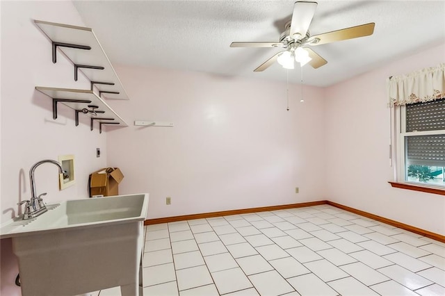 interior space with ceiling fan and a textured ceiling