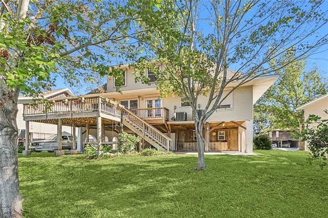 back of property featuring cooling unit, a yard, and a wooden deck