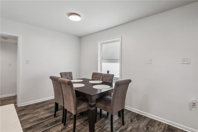 dining space with dark hardwood / wood-style flooring