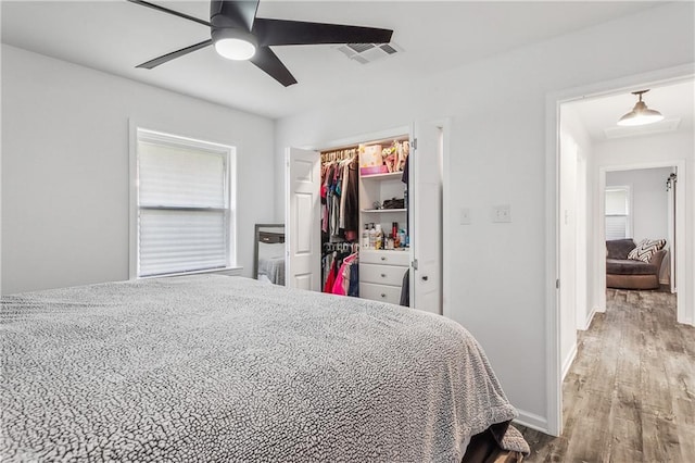 bedroom with wood-type flooring, a closet, and ceiling fan