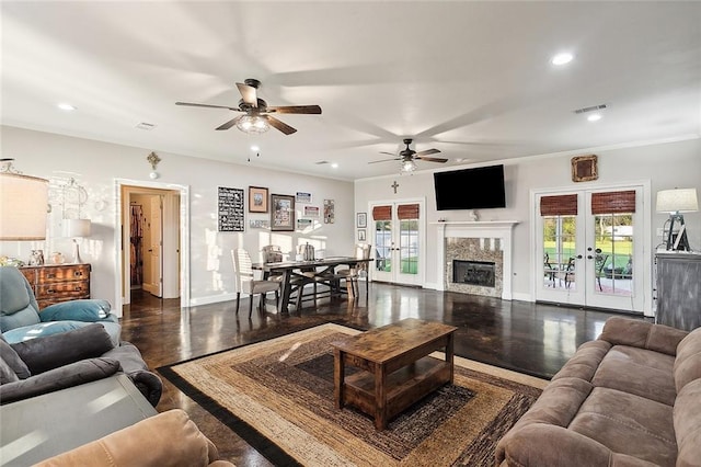 living room with french doors, ornamental molding, ceiling fan, and dark wood-type flooring