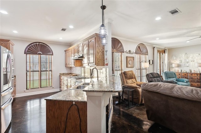 kitchen with sink, crown molding, hanging light fixtures, and tasteful backsplash