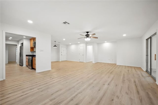 unfurnished living room with ceiling fan and light wood-type flooring