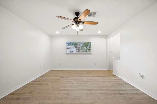 spare room featuring ceiling fan and light hardwood / wood-style floors