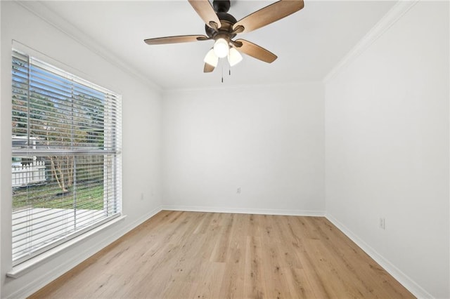 unfurnished room featuring light wood-type flooring, crown molding, and a wealth of natural light