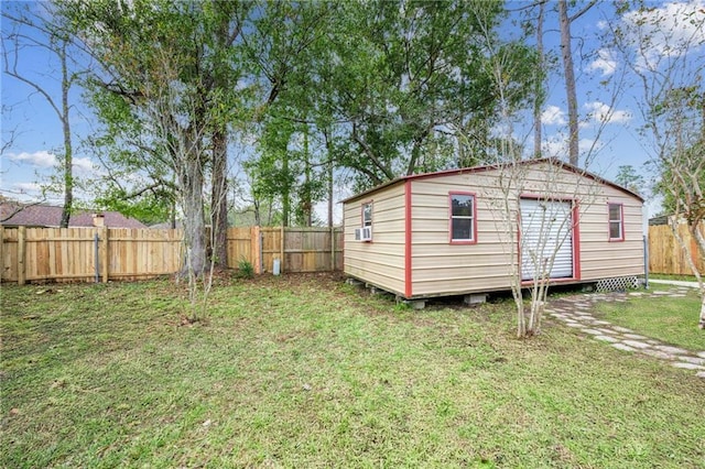 view of outbuilding featuring cooling unit and a lawn