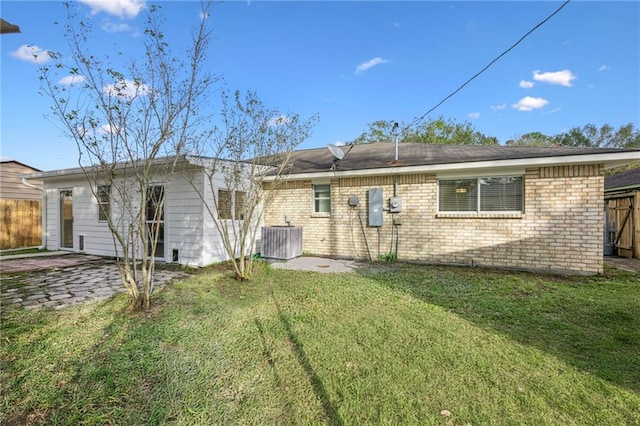 back of house with a yard, a patio, and central AC