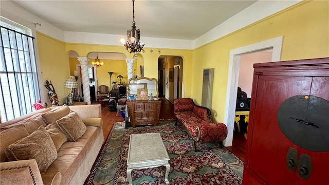 living room with hardwood / wood-style floors and an inviting chandelier