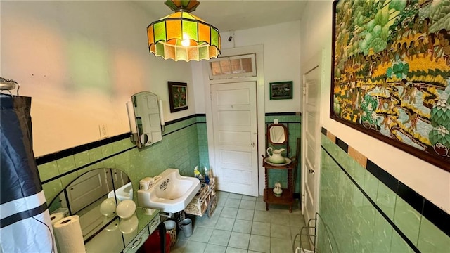 bathroom with tile patterned flooring and tile walls