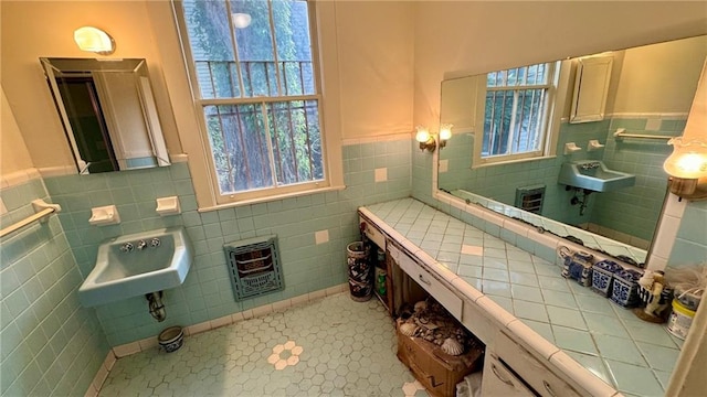 bathroom with tile patterned floors, plenty of natural light, tile walls, and heating unit