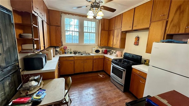 kitchen with ceiling fan, sink, dark hardwood / wood-style floors, crown molding, and black appliances