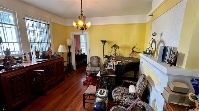 sitting room featuring dark hardwood / wood-style floors and a notable chandelier