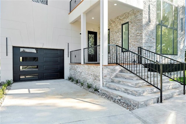 doorway to property with a porch and a garage