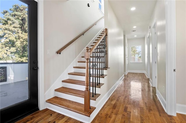 stairs featuring hardwood / wood-style floors