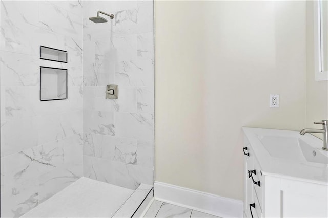 bathroom featuring vanity and tiled shower