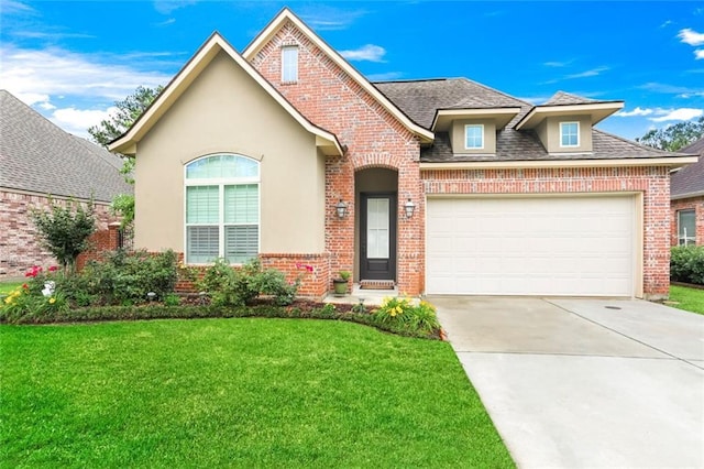 view of front of home with a front yard and a garage