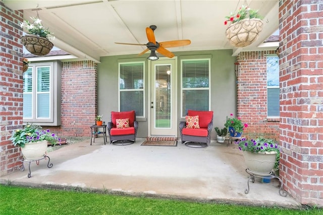 entrance to property with a patio area and ceiling fan