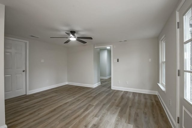 unfurnished room with ceiling fan and wood-type flooring