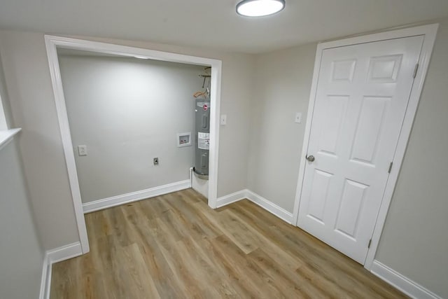 laundry room featuring hookup for an electric dryer, light wood-type flooring, hookup for a washing machine, and water heater