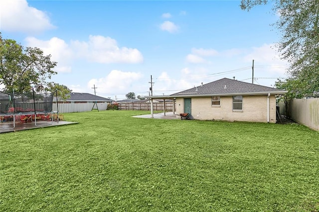 view of yard with a patio area and a trampoline