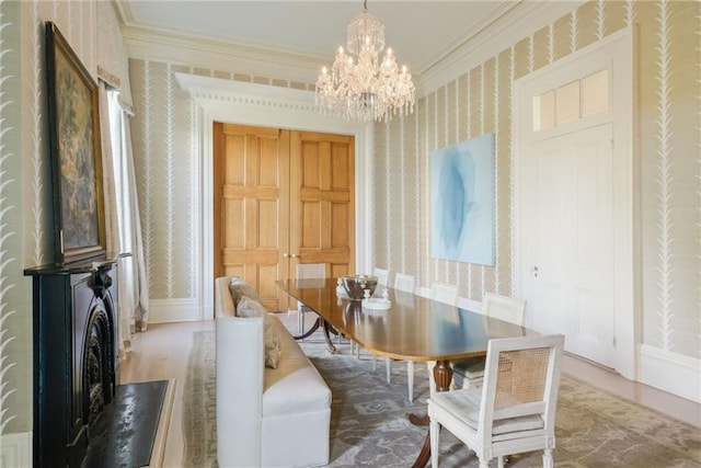 dining space with ornamental molding and a notable chandelier