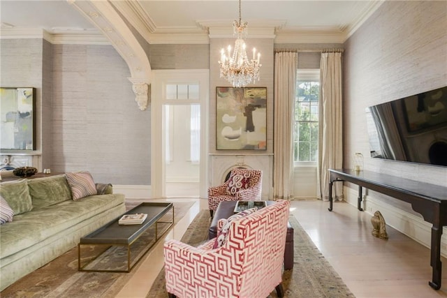 interior space featuring wood-type flooring, a notable chandelier, and ornamental molding