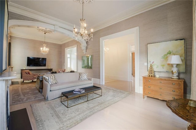 living room featuring a notable chandelier, crown molding, and wood-type flooring