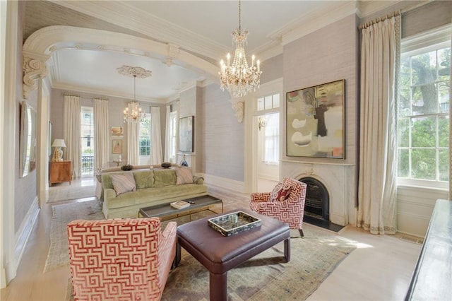 sitting room featuring ornamental molding and an inviting chandelier