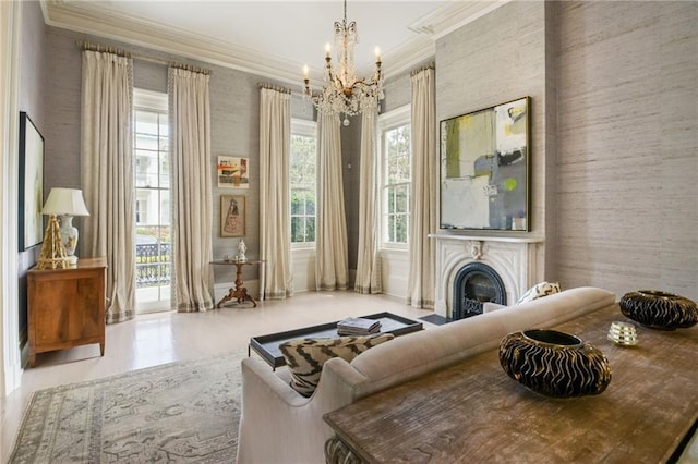 living area featuring a fireplace, ornamental molding, and a notable chandelier