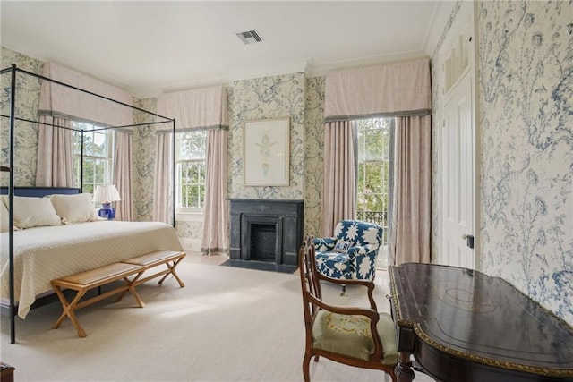 bedroom with crown molding, multiple windows, carpet flooring, and a large fireplace