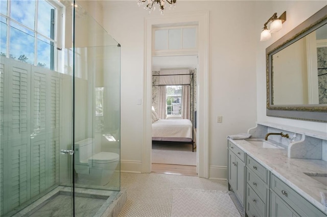 bathroom featuring toilet, a chandelier, tile patterned floors, vanity, and a shower with door