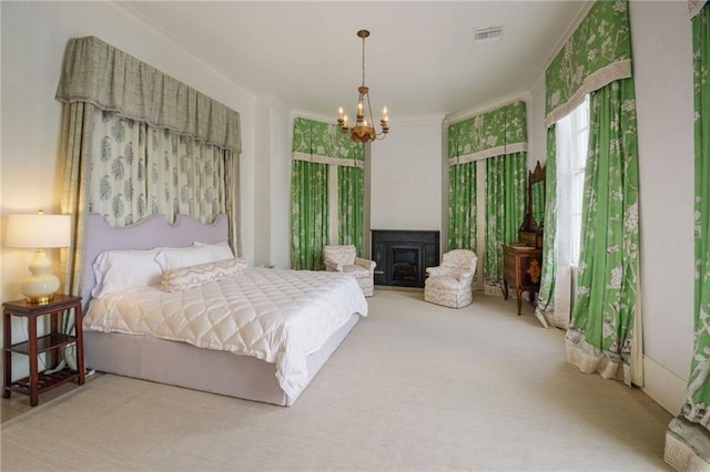 bedroom featuring carpet, ornamental molding, and an inviting chandelier