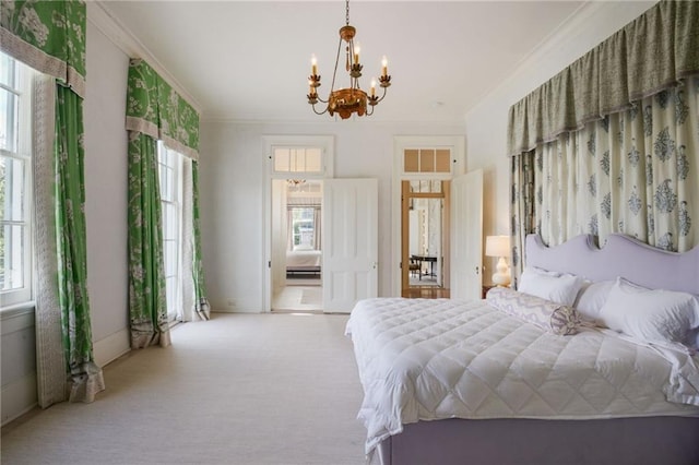 carpeted bedroom featuring crown molding and a chandelier