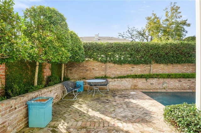 view of patio / terrace featuring a fenced backyard and a fenced in pool