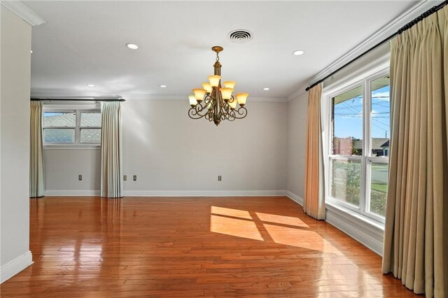 136 Rebel Ave, River Ridge, LA 70123 - empty room featuring healthy amount of natural light, crown molding, a chandelier, baseboards, and light wood-type flooring
